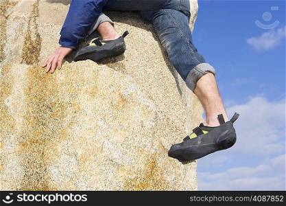 Climber free climbing boulder