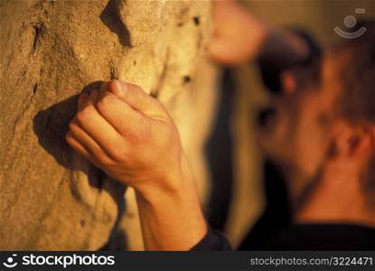 Climber Grabbing Rock