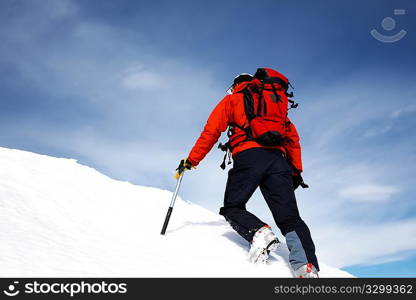 Climber on a snowy ridge; horizontal frame. Italian alps.