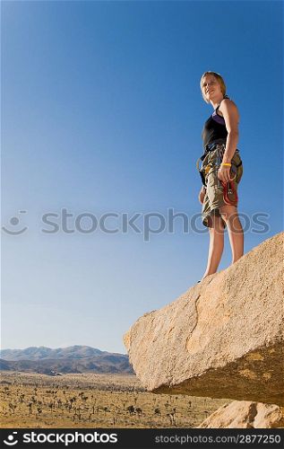 Climber on Rock Looking at Desert