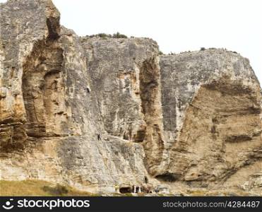 climbers climb on rock in Crimean Mountains near Bakhchisarai city