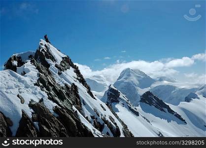 Climbers, on background the peaks and glaciers of Monte Rosa massif, west Alps, Europe