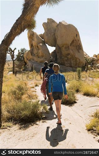 Climbers Walking Through Desert