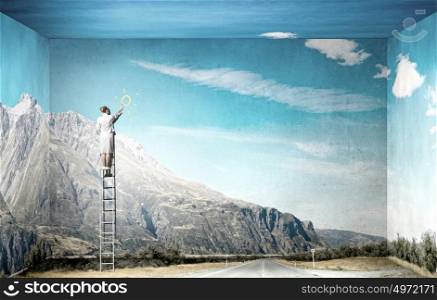 Climbing to success. Businesswoman standing on ladder and drawing on wall
