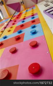 Climbing wall playground interior, entertainment center. Area for climbers trainings, active sport for children and youth. Climbing wall playground, entertainment center