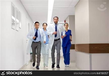 clinic, people, health care and medicine concept - group of medics runing along hospital