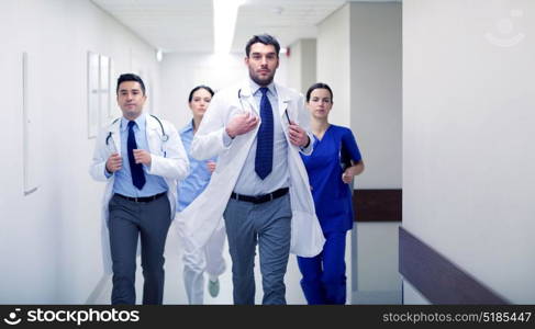 clinic, people, health care and medicine concept - group of medics runing along hospital. group of medics walking along hospital