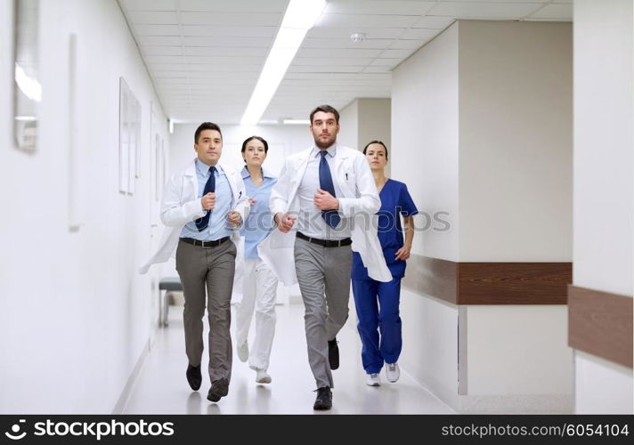 clinic, people, health care and medicine concept - group of medics runing along hospital