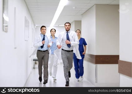 clinic, people, health care and medicine concept - group of medics runing along hospital