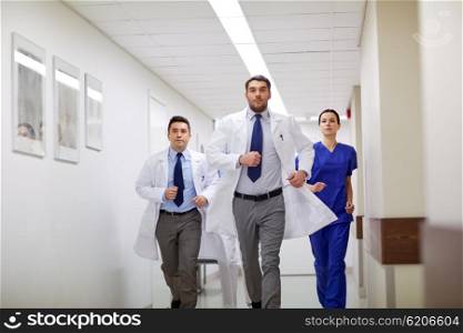 clinic, people, health care and medicine concept - group of medics runing along hospital