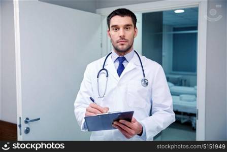 clinic, profession, people, health care and medicine concept - doctor with stethoscope and clipboard at hospital corridor. doctor with stethoscope and clipboard at hospital