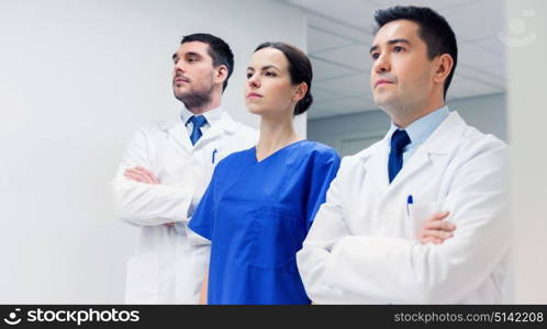 clinic, profession, people, health care and medicine concept - group of medics or doctors at hospital corridor. group of medics or doctors at hospital