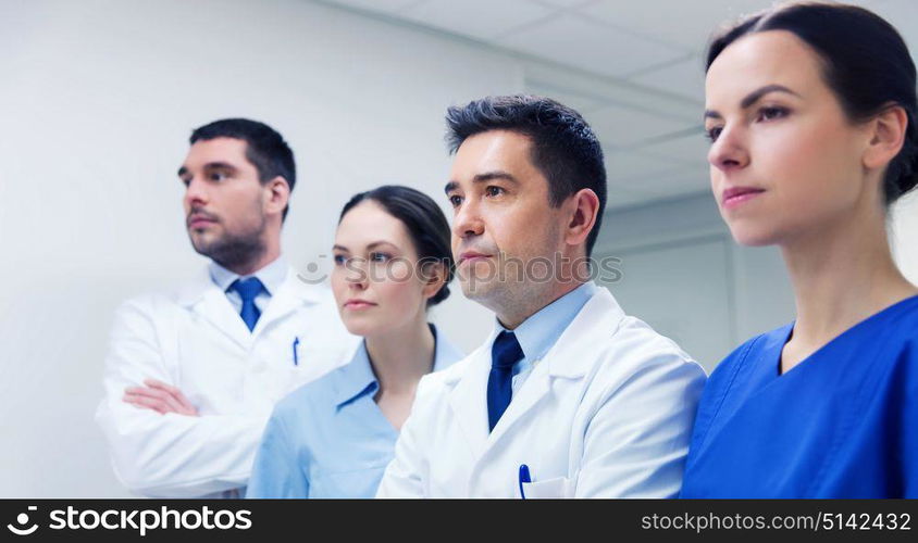 clinic, profession, people, health care and medicine concept - group of medics or doctors at hospital corridor. group of medics or doctors at hospital