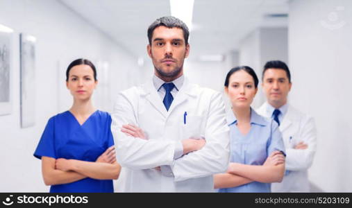 clinic, profession, people, health care and medicine concept - group of medics or doctors at hospital corridor. group of medics or doctors at hospital