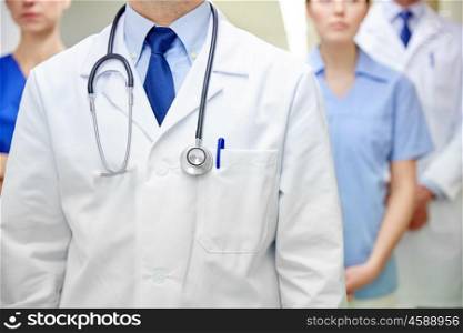 clinic, profession, people, healthcare and medicine concept - close up of medics or doctors and stethoscope at hospital