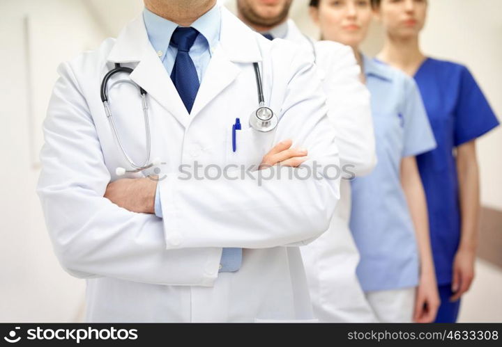 clinic, profession, people, healthcare and medicine concept - close up of medics or doctors at hospital corridor