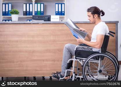 Clinic reception counter and young patient. Young man at hospital reception desk