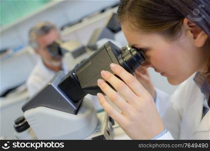 clinical technologist observing a sample