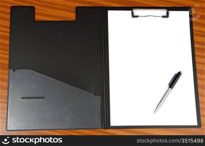 Clipboard and pend a over wood background