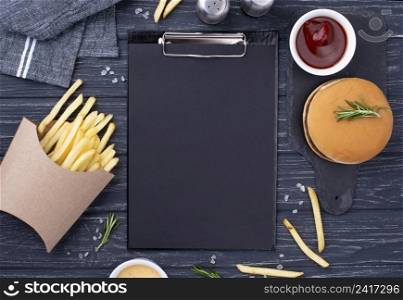 clipboard beside hamburger with fries