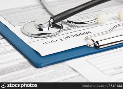 clipboard with medical form and stethoscope