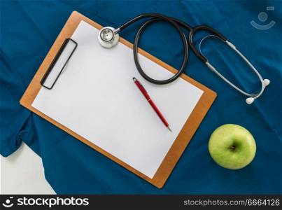 Clipboard with stethoscope on doctor&rsquo;s shirt.. Clipboard with stethoscope on doctor&rsquo;s shirt