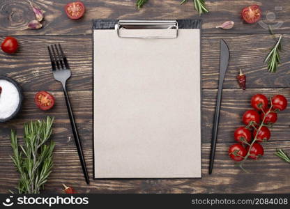 clipboard with tomatoes cutlery table
