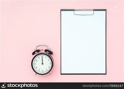 Clipboard with white blank paper and black alarm clock on pink background. Empty card for to-do list, schedule, plan and other text, design. Time, deadline or reminder concept. Flat lay Mockup.. Clipboard with white blank paper and black alarm clock on pink background. Empty card for to-do list, schedule, plan and other text, design. Time, deadline or reminder concept. Flat lay Mockup