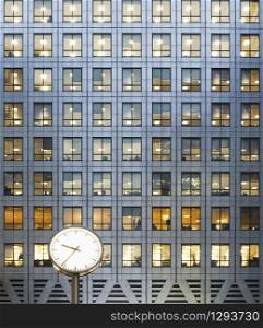 Clock and office windows at dusk