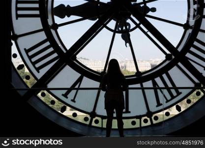 Clock at the Musee D'Orsay in Paris France. In the back we see the Sacre Coeur Basilica in Montmatre