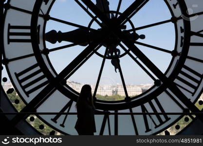 Clock at the Musee D'Orsay in Paris France. In the back we see the Sacre Coeur Basilica in Montmatre