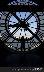 Clock at the Musee D&rsquo;Orsay in Paris France. In the back we see the Sacre Coeur Basilica in Montmatre