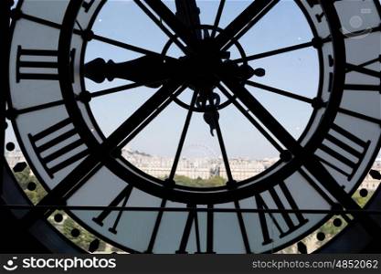 Clock at the Musee D&rsquo;Orsay in Paris France. In the back we see the Sacre Coeur Basilica in Montmatre