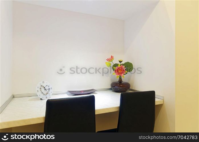 clock, candle and flower on the table
