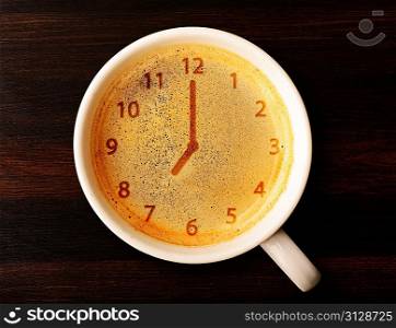 clock. cup of fresh espresso with clock sign, view from above