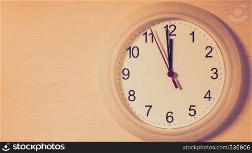 Clock hanging on wall ticking showing twelve hours. Clock ticking showing twelve hours