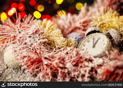 Clock in snow-covered Christmas ornaments with focus on arrows. Clock in snow-covered Christmas ornaments