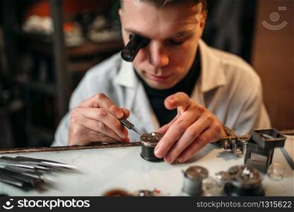 Clock maker repair old clockwork gear. Mechanical watches repairing. Clock maker repair old clockwork gear