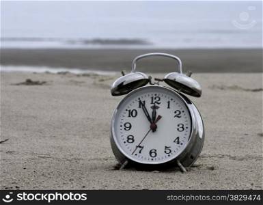 clock on the beach with time five for twelfe