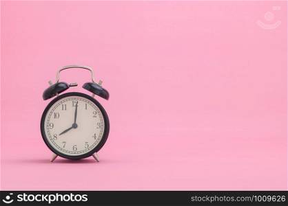 clock showing time on a pink background