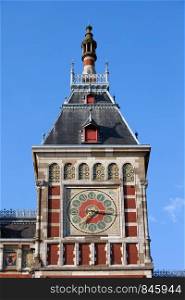 Clock tower of the Central Train Station in Amsterdam, Holland, Netherlands.