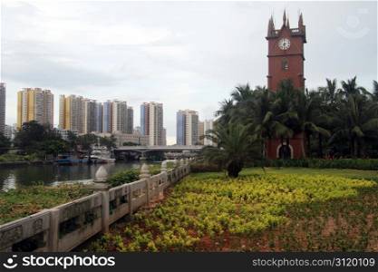Clock tower on the bank on canal in Haykou, Hainan, China