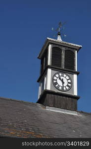 clock tower with weather vane on top of a building in Gloucester, England