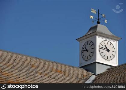 clock tower with weather vane on top of a building in Gloucester, England