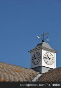 clock tower with weather vane on top of a building in Gloucester, England