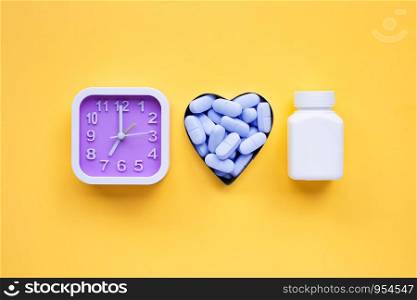 "Clock with "PrEP" ( Pre-Exposure Prophylaxis). used to prevent HIV on yellow background. Top view"