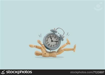 Clocks on the wooden puppet Isolated on pink background, Show your work until you have no time untill stress, Idea and concept of time picture with copy space to write.