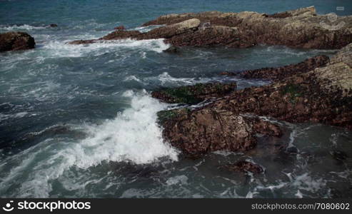 Cloe up view of waves crashing on rocks near Spoonera??s Cove