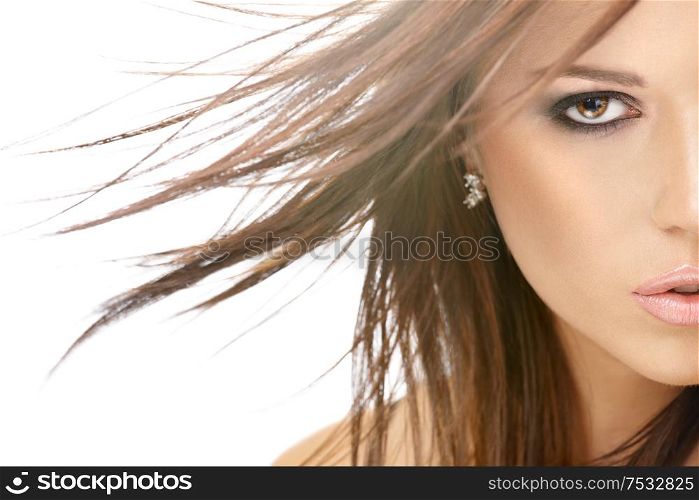 Close up - a half of face of beauty with flying hair, isolated