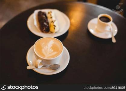 close up a mug of fragrant cappuccino and a sweet dessert on the table